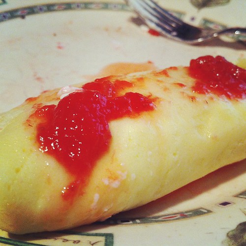 Husband-crafted crepes with homemade strawberry sauce and cottage cheese filling